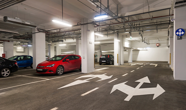 Parking garage with red car parked