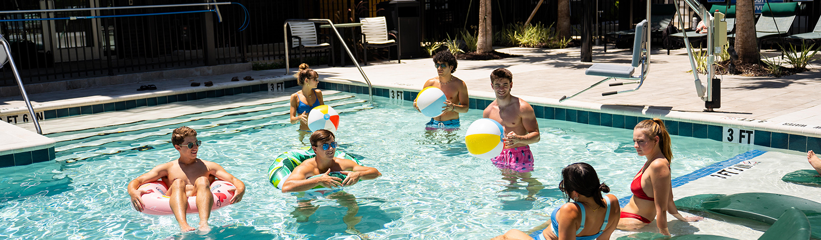group of friends hanging out at the pool