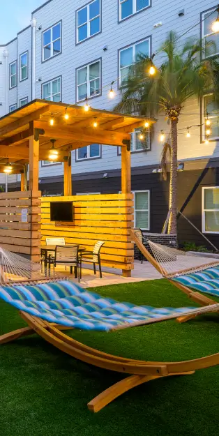 an outdoor lounge area with hammocks