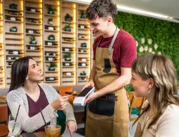 a waiter processing a woman's order