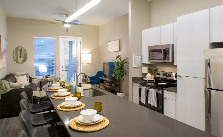 a furnished student apartment kitchen with stainless steel appliances